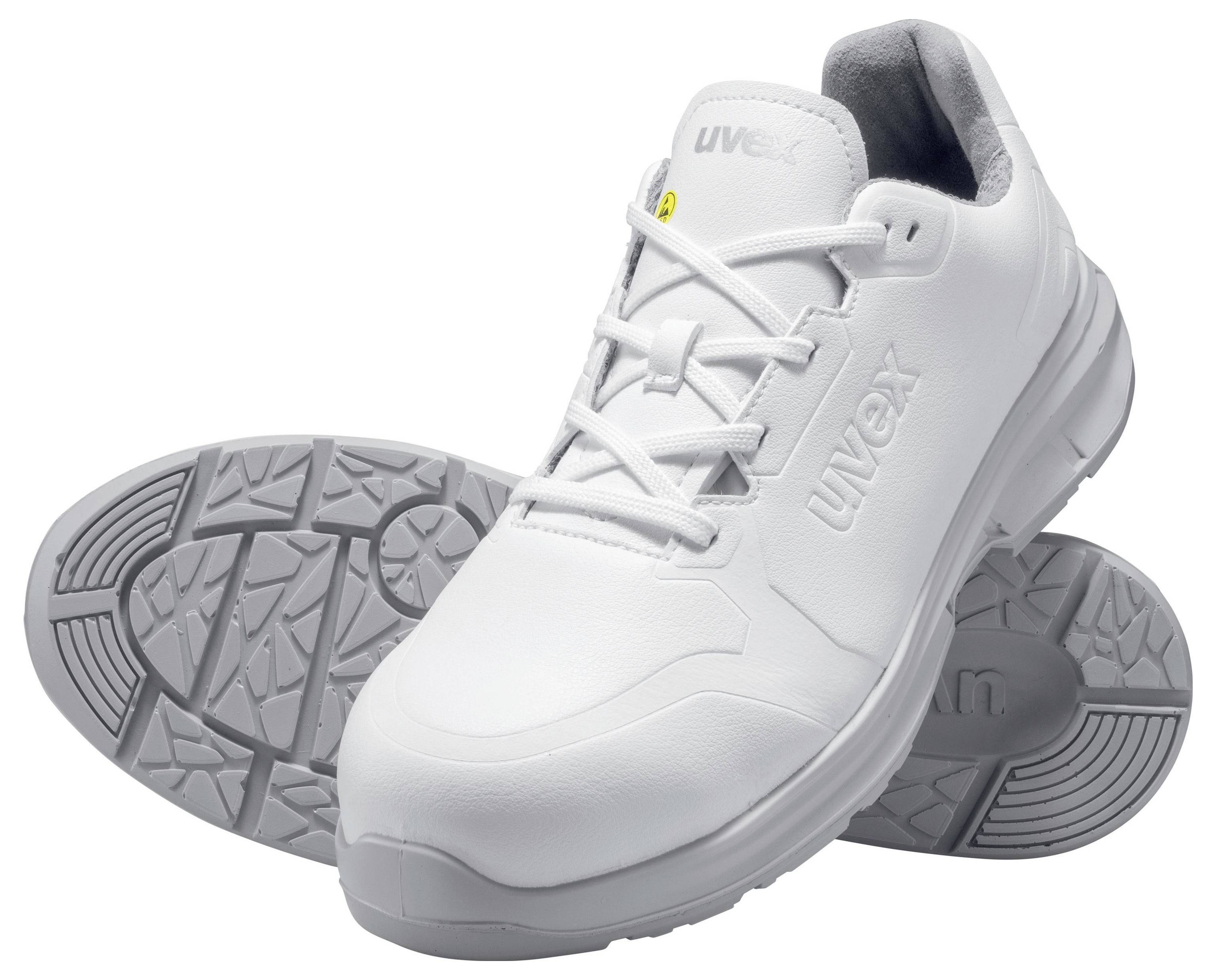 White safety shoes with non-slip sole, shown from the side and bottom. 'Uvex' brand logo visible. Suitable for occupational safety.