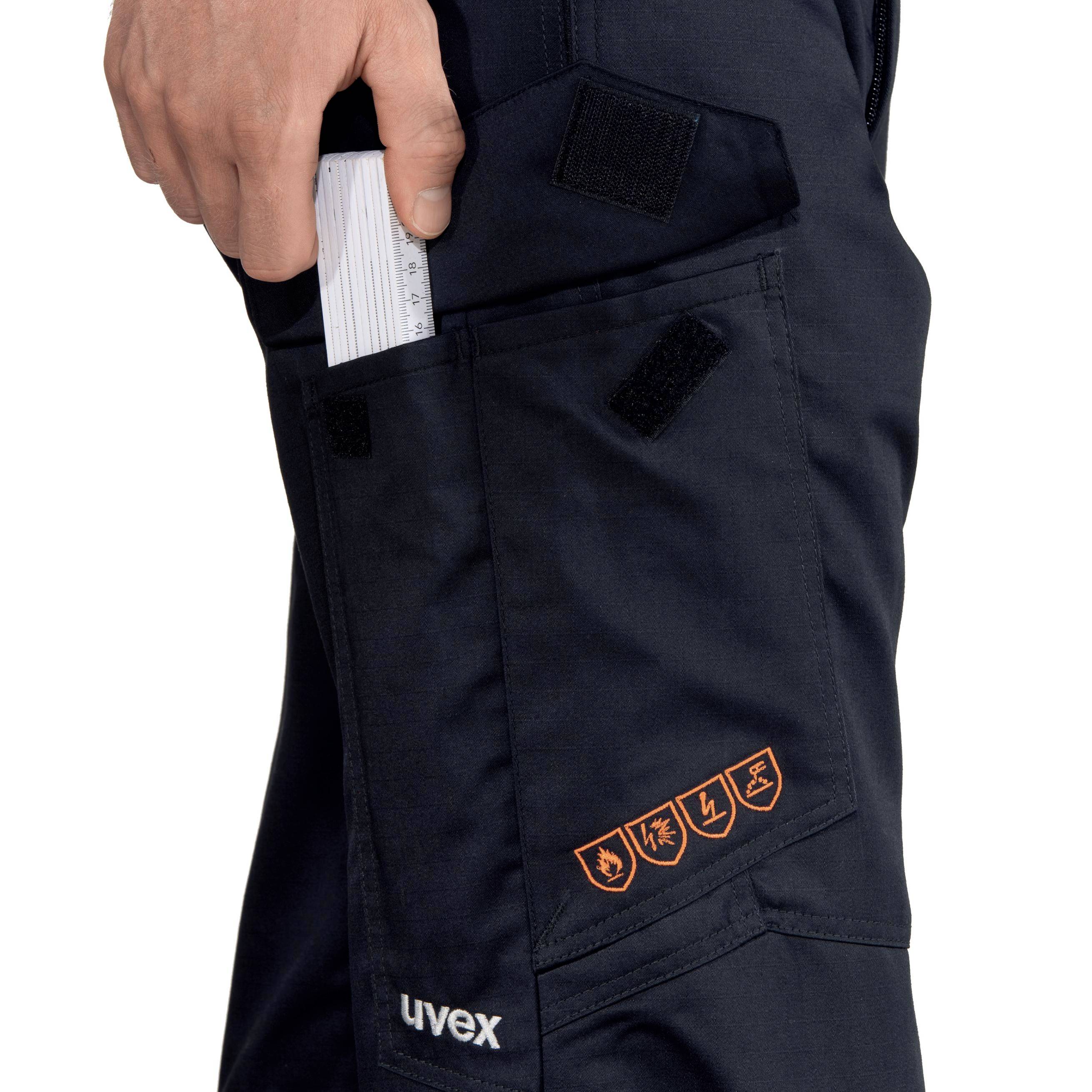 'A man pulls a white notepad from a black bag with orange symbols for protective clothing.'