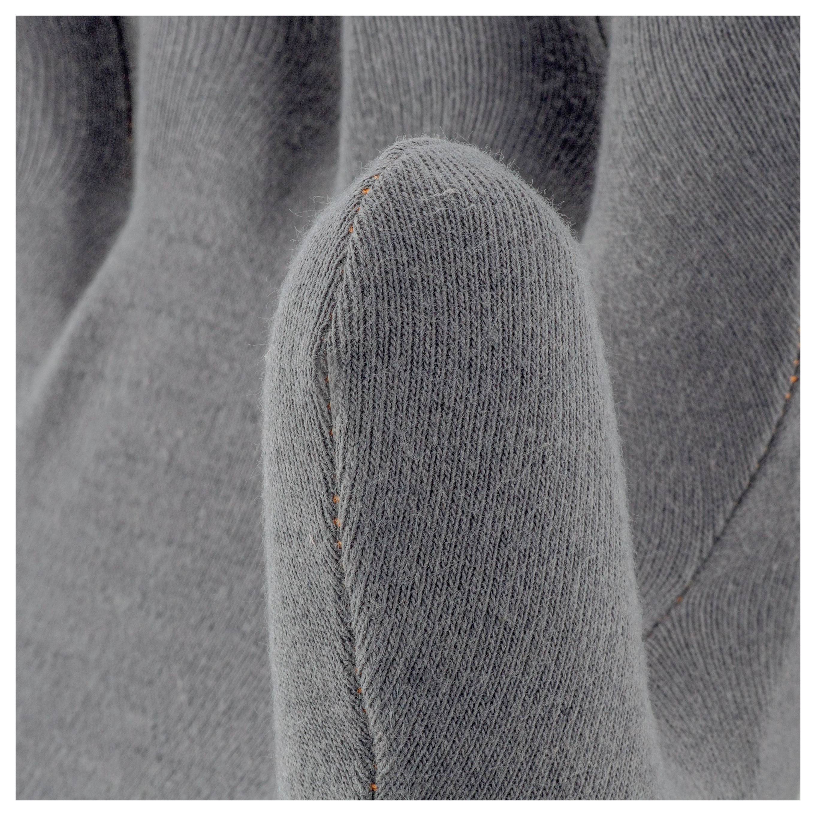 Grey fabric work glove, close-up of the thumb and index finger, showing material structure and seam details.