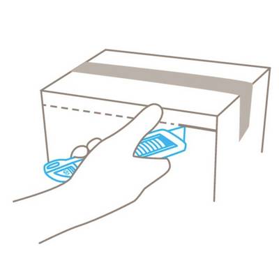 A hand guides a sharp tool along the dotted line on a cardboard box in order to open it.