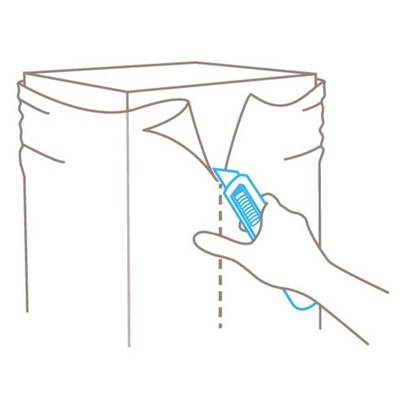 A hand holds a craft knife and cuts along a marked line on a cardboard box to open it.