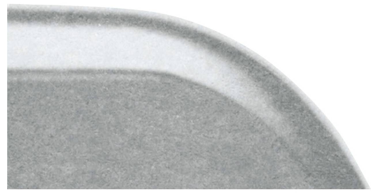 The upper section of a grey metal surface with a rounded corner; shows a smooth and polished edge.