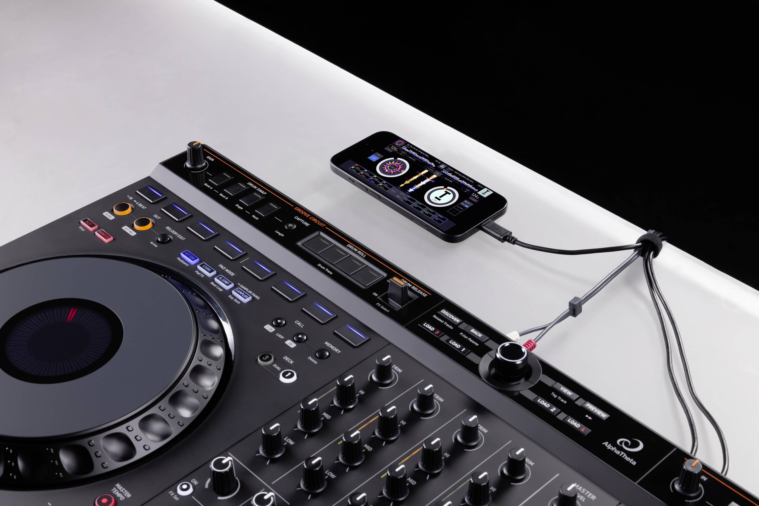 DJ console with mixing desk and smartphone connection, showing music control via an app.