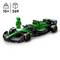 Toy racing car made from building blocks with a green and black bodywork, next to a green figurine. Suitable for ages 10 and above.