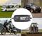 Battery charger displaying '13.8V' and 'Intelligent' in the centre, surrounded by motorhome, SUV, motorcycle, and tractor in a rural setting.