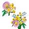 A vibrant bouquet of pink, yellow, and blue flowers with intricate blooms and green leaves, artistically arranged.