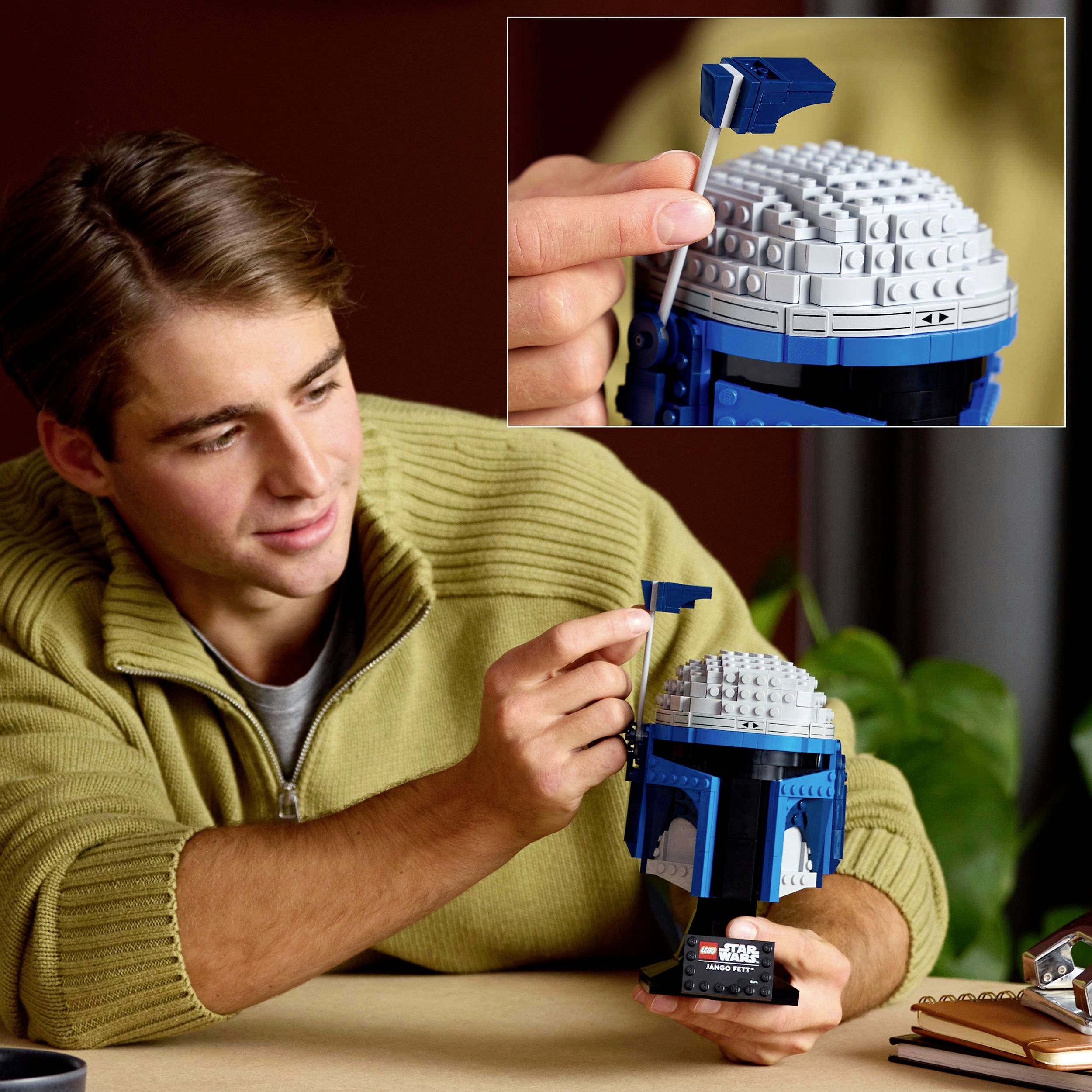 A person is holding a LEGO bust of a character from a science fiction film. A detachable plate is shown.