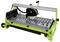Green tile cutter with diamond saw blade, water pump, and guide rail for precise tile cutting.