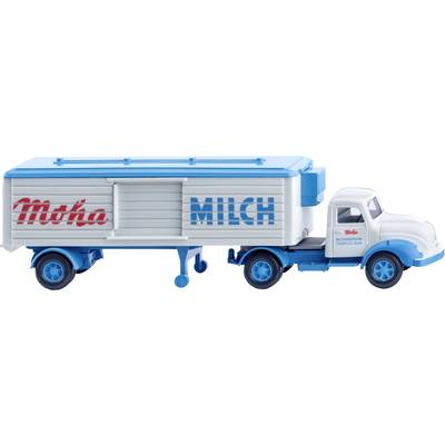 A model lorry with the inscription 'Moha MILK' is transporting milk. The trailer has blue and white colours with red lettering.