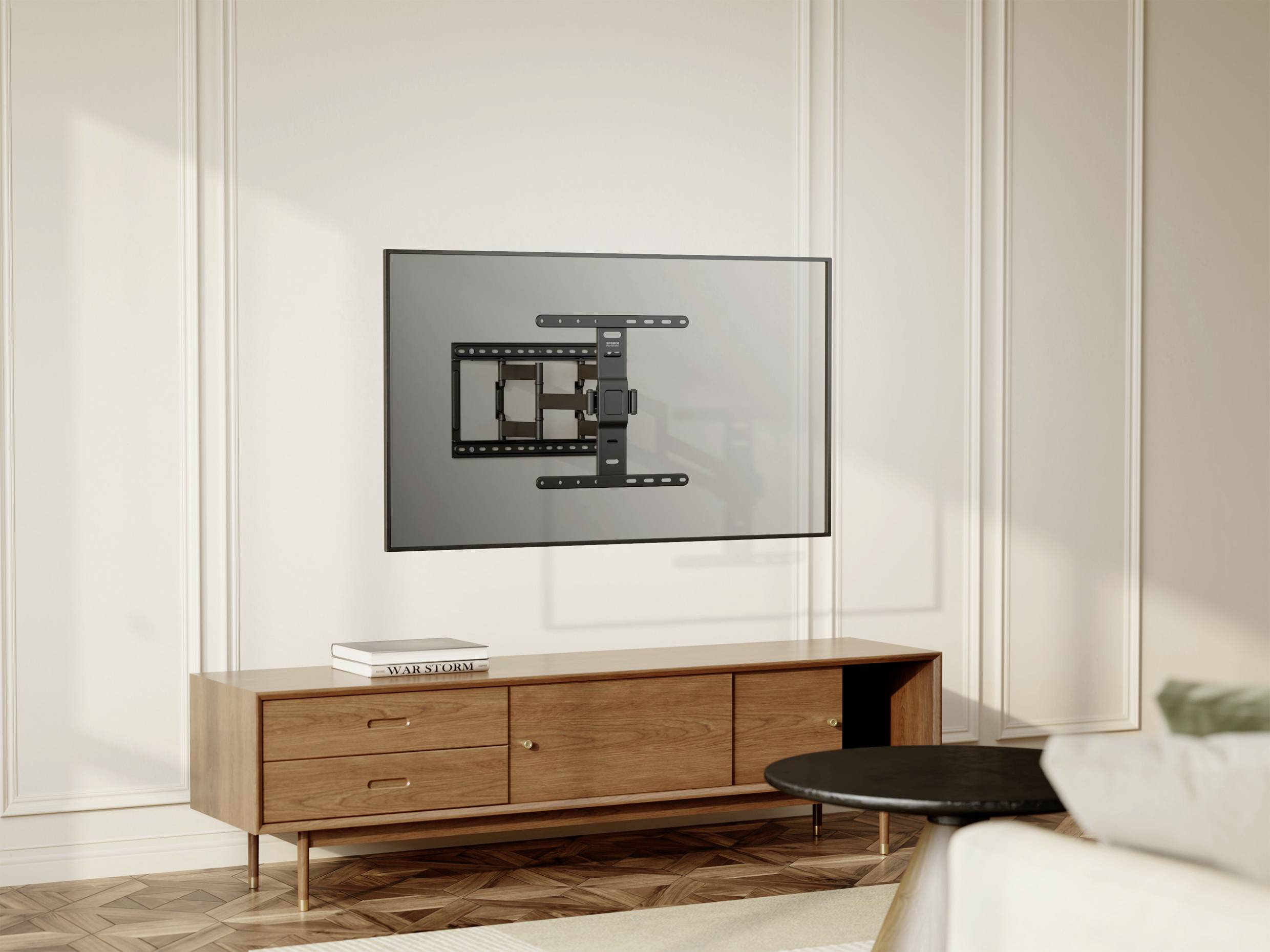 A modern room with a bright wall, on which a television is mounted on a bracket. Beneath it stands a wooden piece of furniture.