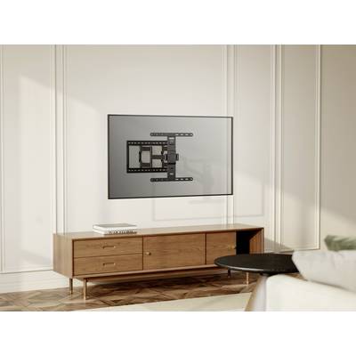 A modern room with a bright wall, on which a television is mounted on a bracket. Beneath it stands a wooden piece of furniture.