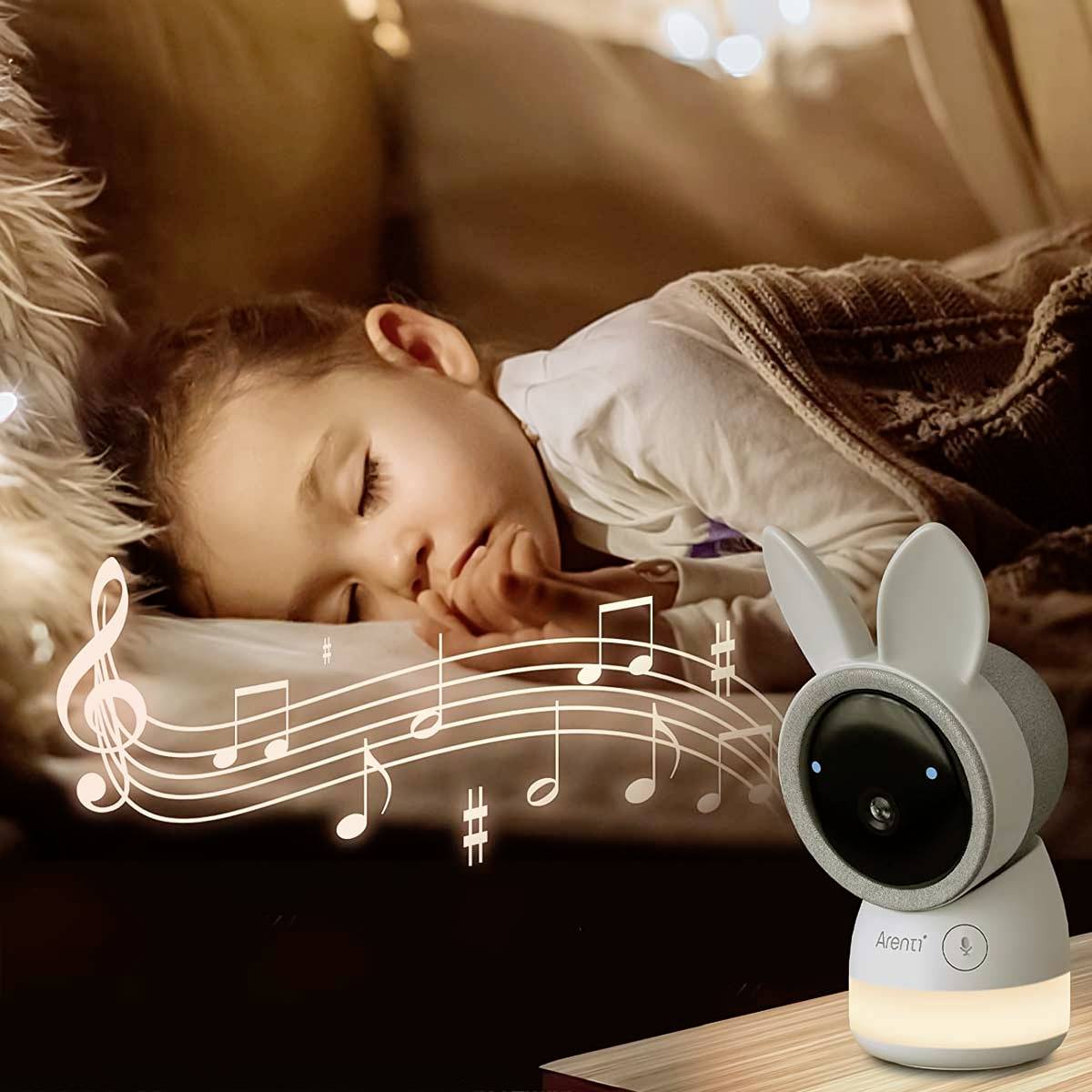 A sleeping child in a bed, accompanied by a musical note graphic. A camera in the shape of an animal head observes the scene.