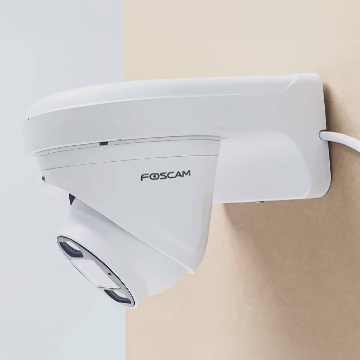 A Foscam surveillance camera is mounted on a light-coloured wall.