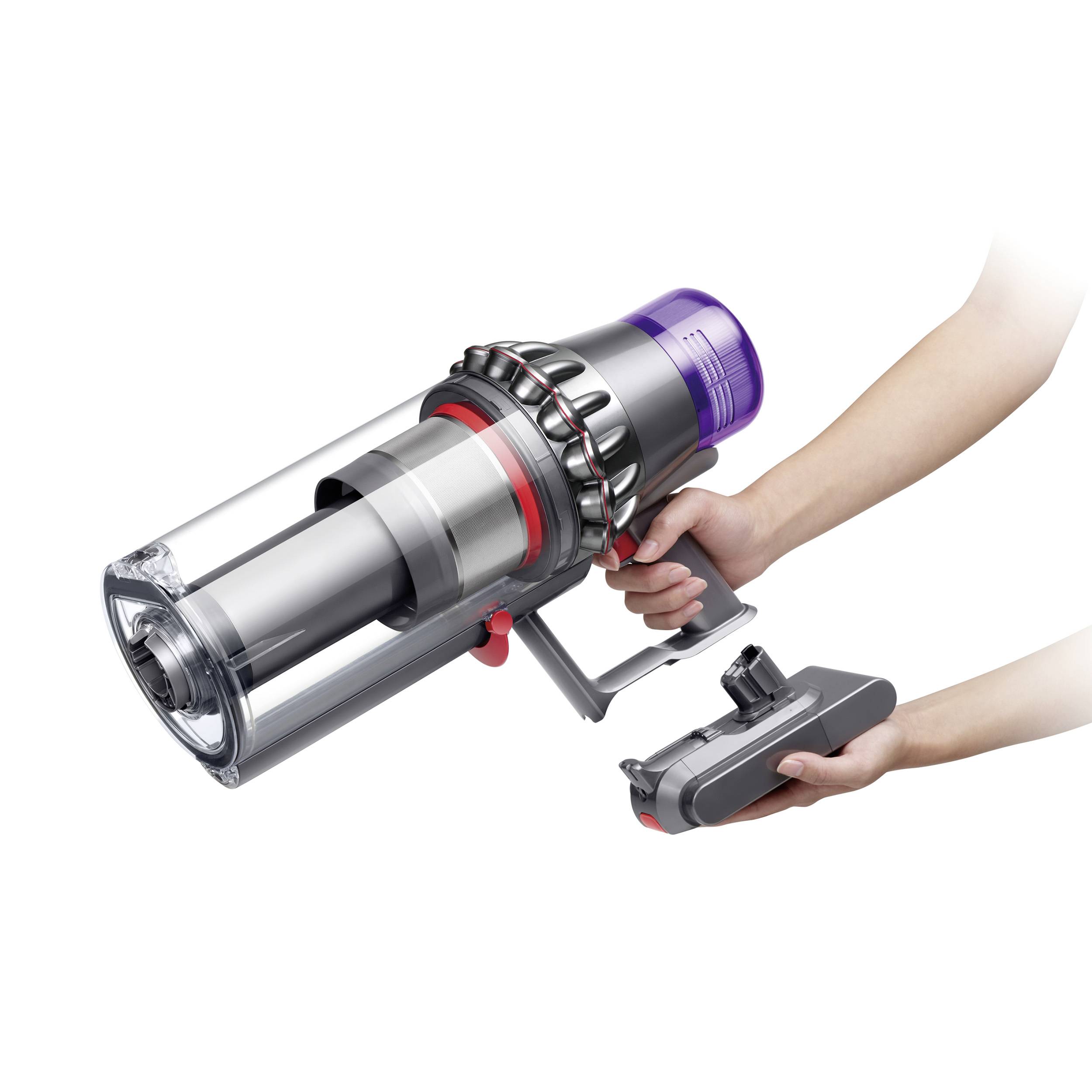 A vacuum cleaner is operated with one hand. The device is cordless and features a modern design with a transparent dust container.