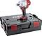 A cordless drill in red and grey sits on a black tool case.