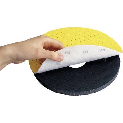 Hand lifts an abrasive sanding pad with yellow, perforated top material, white intermediate layer, and black base.