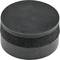 A black rubber ice hockey puck lies on a surface.