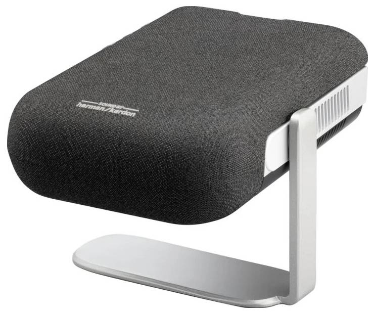 A compact, black speaker with a silver stand, 'Harman Kardon' lettering on the top, sitting on a table.