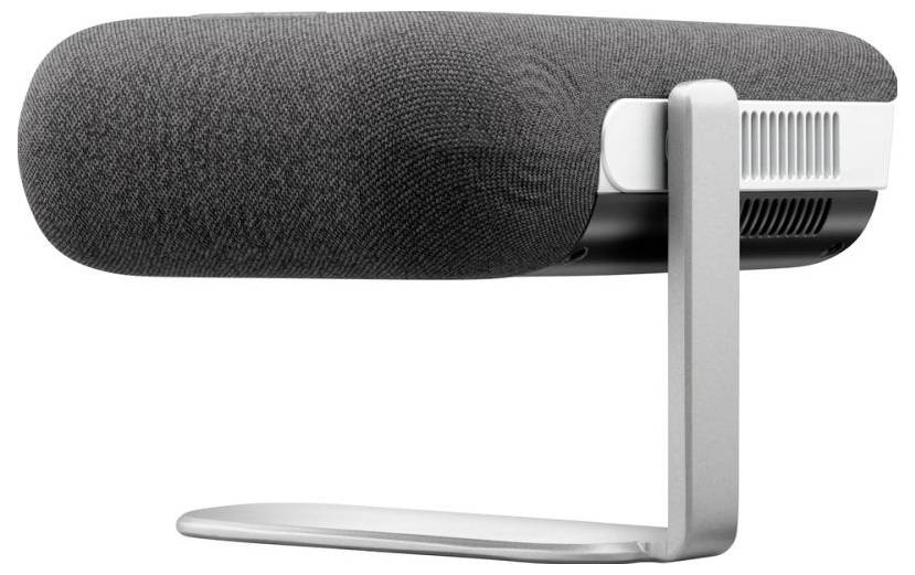 A grey microphone with a fabric cover stands on a silver stand.