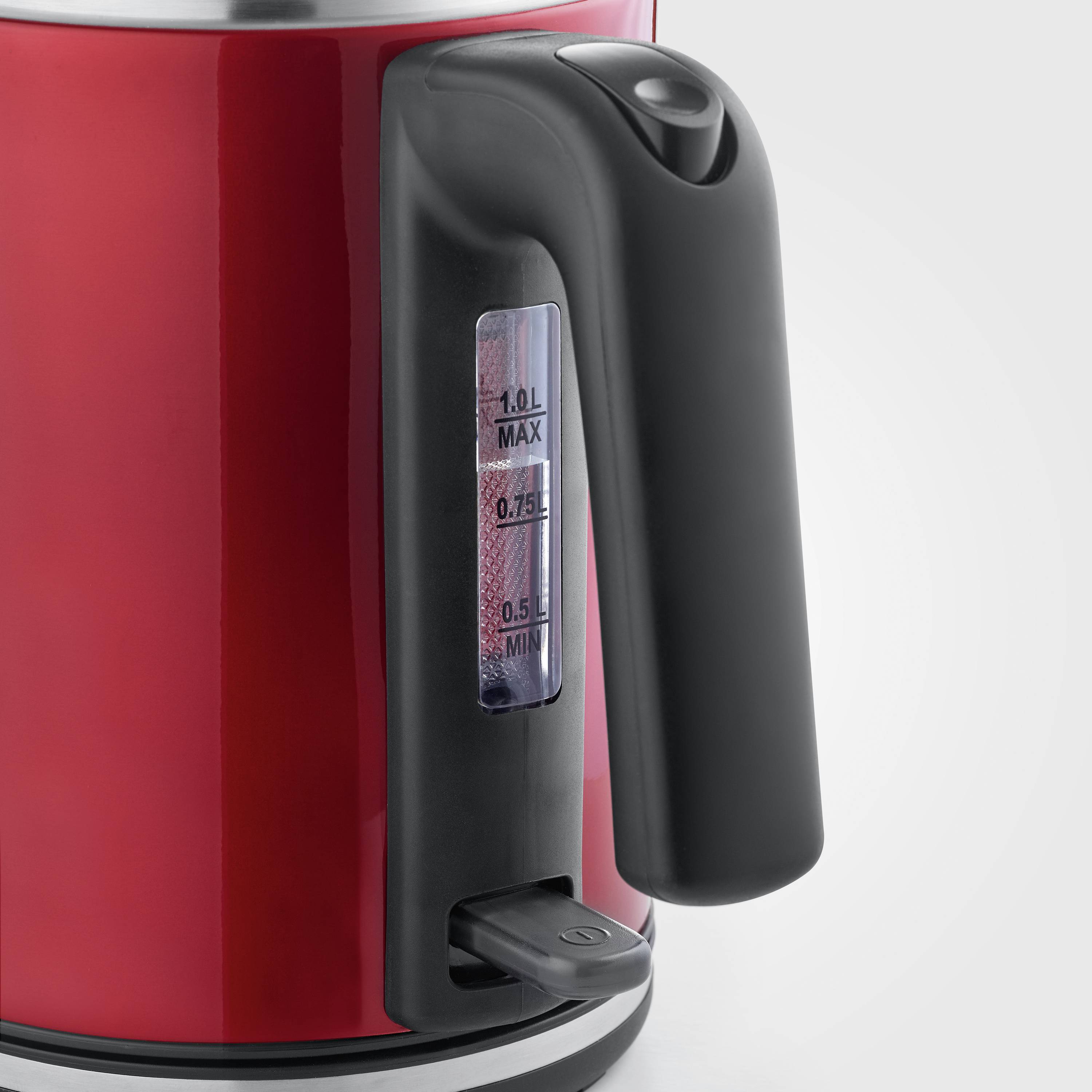 Red kettle with black handle, showing water level indicator with markings for 0.5 l, 0.7 l, and 1.0 l fill levels.