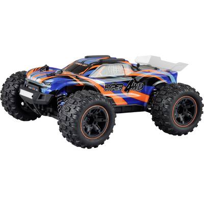 Remote-controlled toy car with large, all-terrain tyres and a colourful, orange and blue striped design, placed on a table.