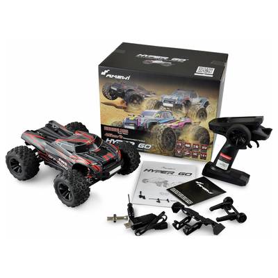 Remote-controlled car with accessories, including control unit and instructions, pictured in front of its original packaging.