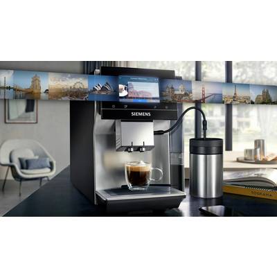 A Siemens coffee machine sits on a table, ready to pour a freshly brewed espresso into a glass cup.