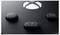 Close-up of three buttons on a black gaming controller, including one button with an upward arrow symbol.