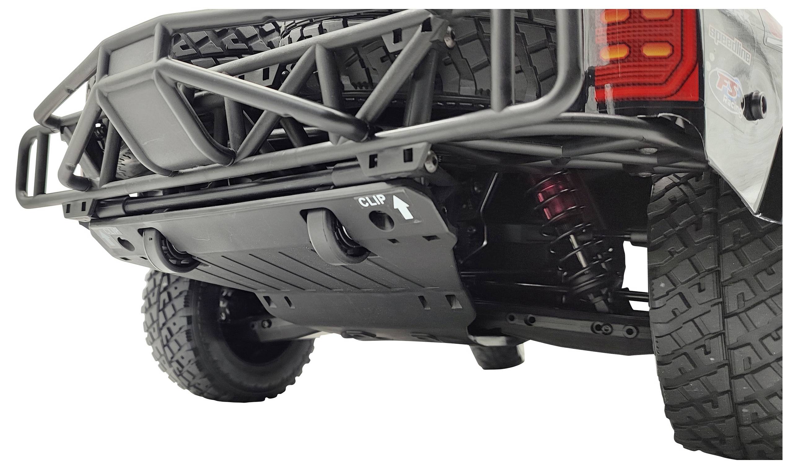 Underside of an off-road vehicle with a secured spare wheel mounting and robust frame, with highlighted 'CLIP' symbol on a plate.
