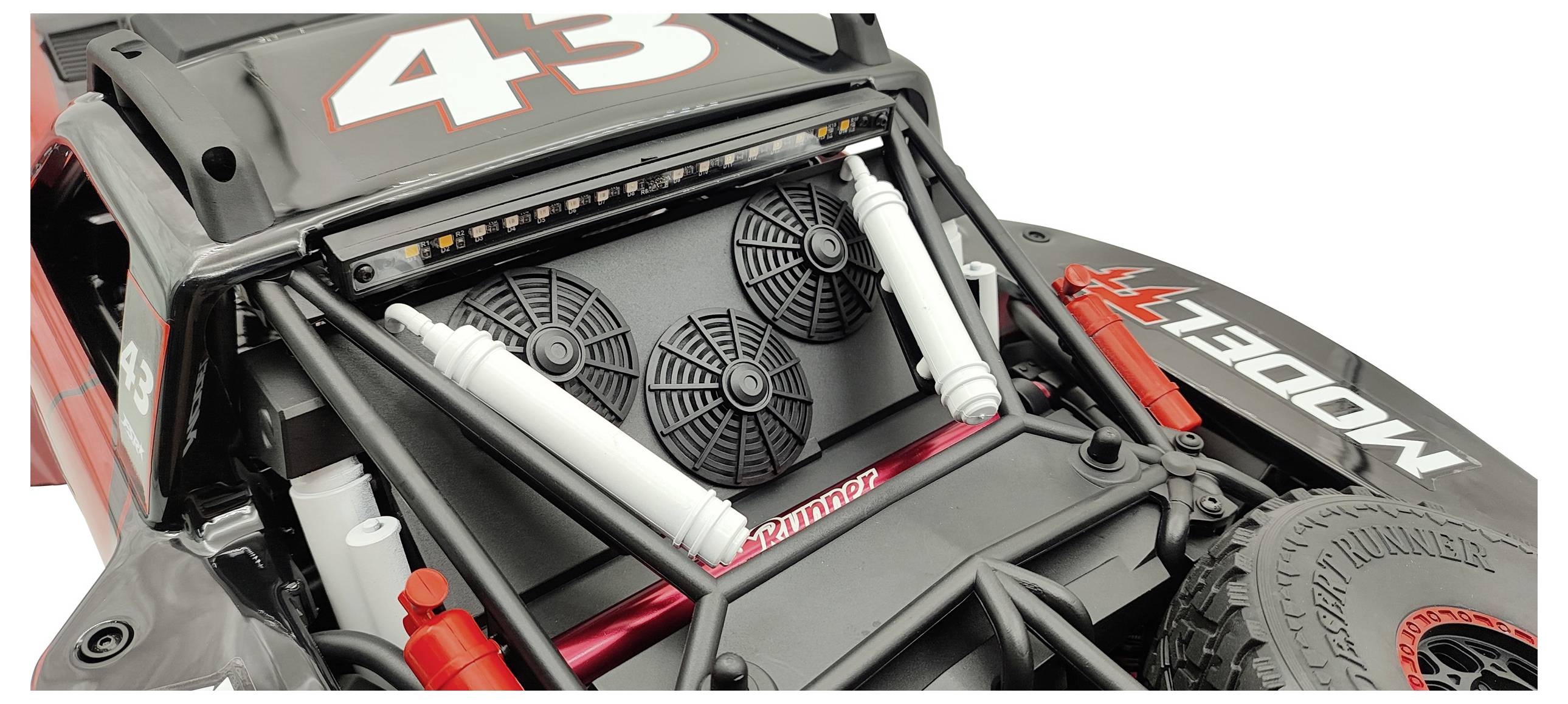 A model car with the number '43' on the bonnet. Suspension struts and a spare wheel are visible.