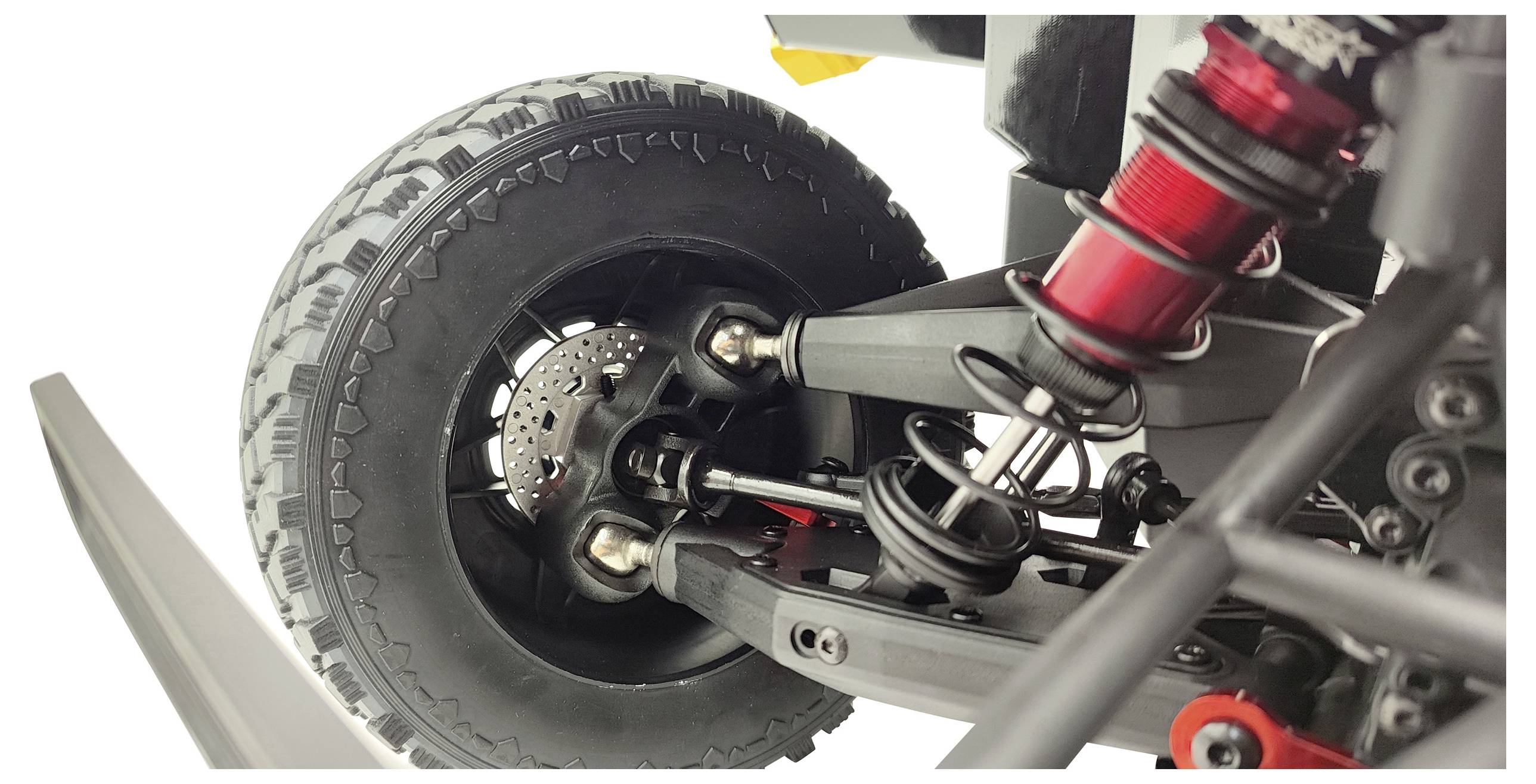 Close-up of an off-road vehicle suspension system with visible shock absorber and wheel suspension – detailed view of mechanical components.