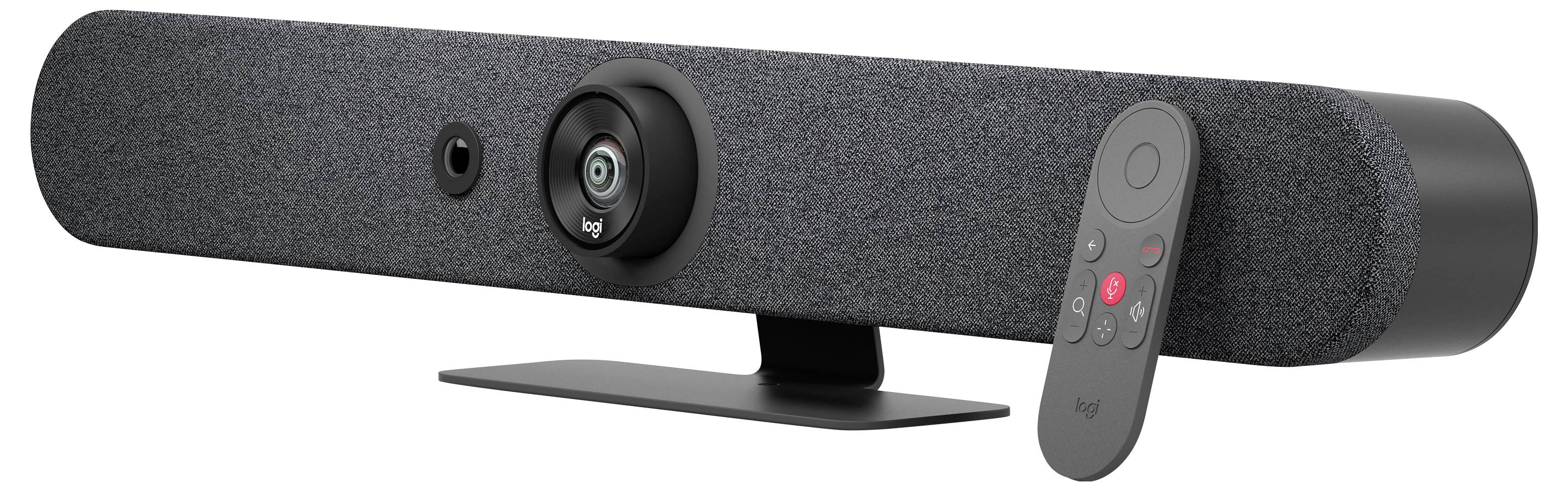 A grey video conference camera with integrated speakers and a detachable tripod. A remote control lies beside it.