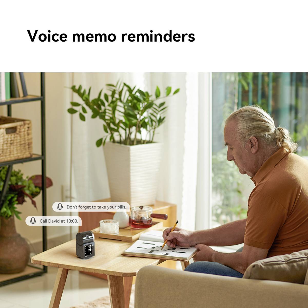 A person is sitting at the table and listening to voice notes with reminders such as 'Call David at 10 o'clock'. Plants can be seen in the background.