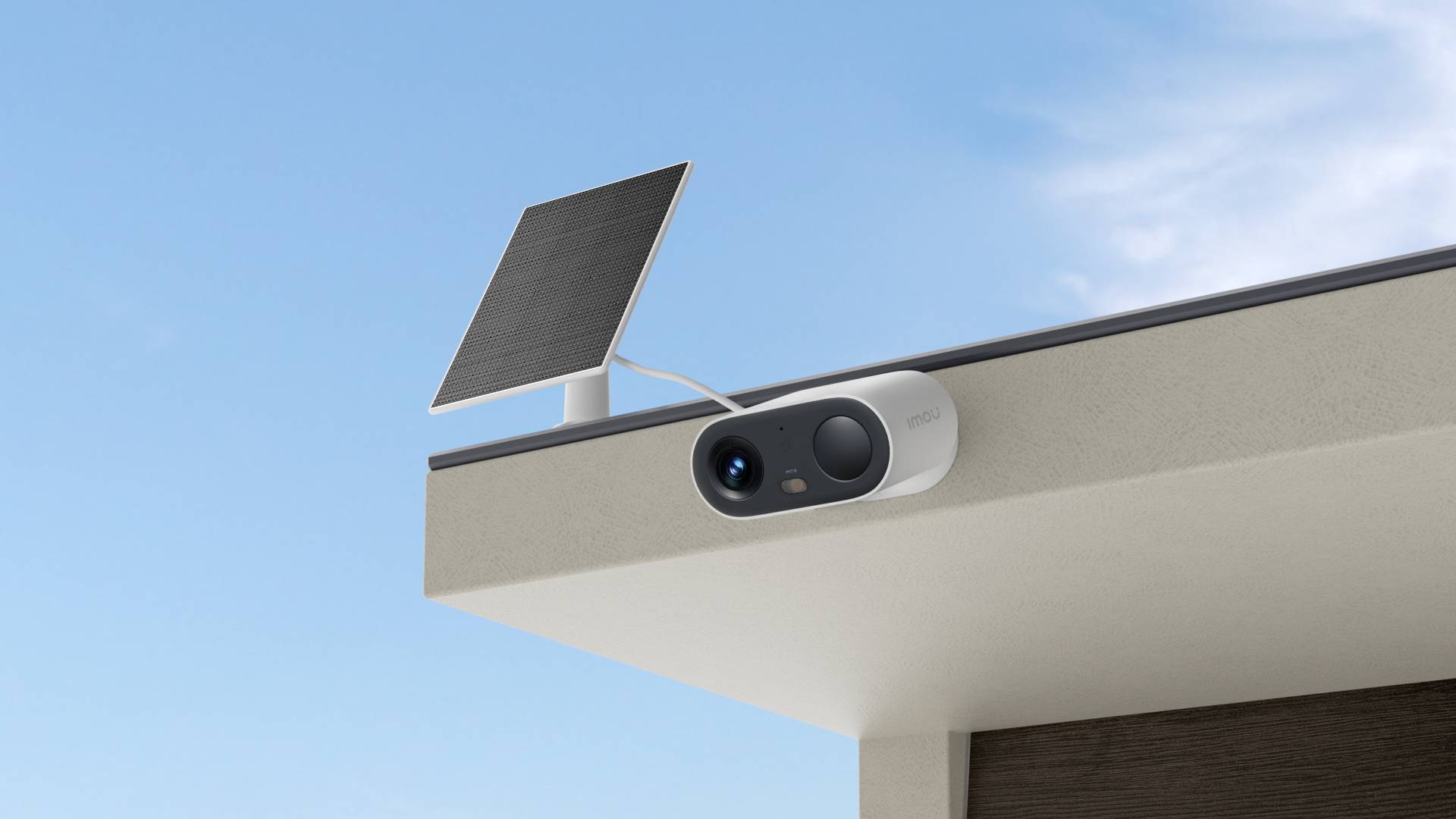 An outdoor camera with a solar panel is mounted on the corner of a building, beneath a clear blue sky.