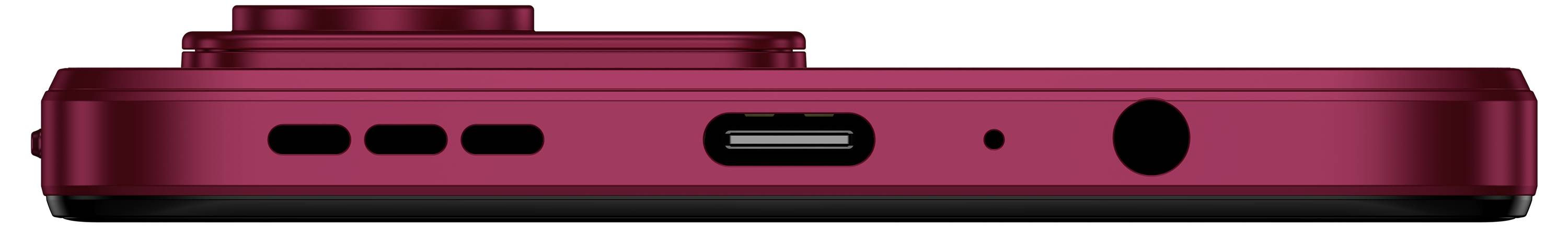 Side view of a red smartphone showing its charging port, speaker holes, and headphone jack.