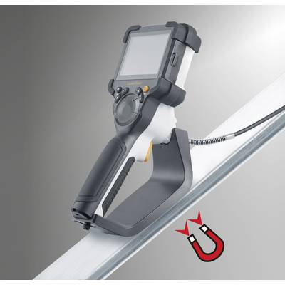A portable testing device with a screen and ergonomic handle rests on a metal surface, with a magnet symbol underneath, indicating magnetic adhesion.