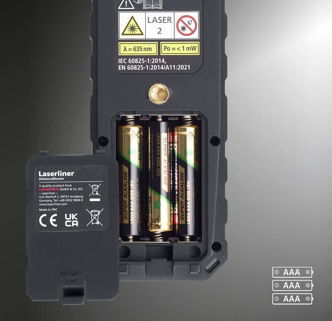 Electronic device with open battery cover. Two AA batteries visible. Laser radiation warning notices on the rear.