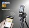 Laser distance measurer on a tripod with digital display. One hand is holding a smartphone with the 'MeasureNote App' for data display.