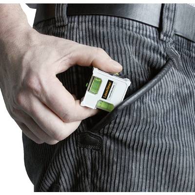 A hand is slipping a small spirit level into a trouser pocket.