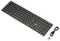 Wireless black keyboard with a compact design, alongside a USB receiver and a charging cable.