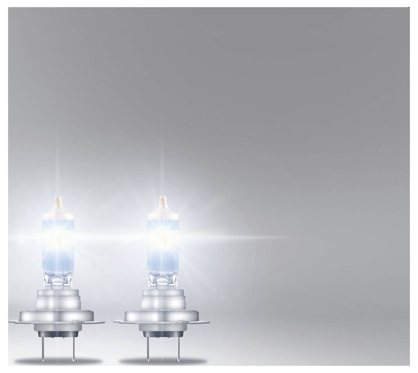 Two glowing light bulbs against a grey background, positioned on the left in the foreground. The light bulbs are emitting strong light.