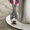 A person is using an adjustable spanner to loosen an apparently stuck screw on a metal surface outdoors.
