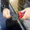 A person is using pliers to secure a cable to a solar panel, symbolising technology and renewable energy.