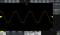 An oscilloscope displays a yellow sine wave with a frequency of 1 kHz on a screen, with axes labelled voltage and time.