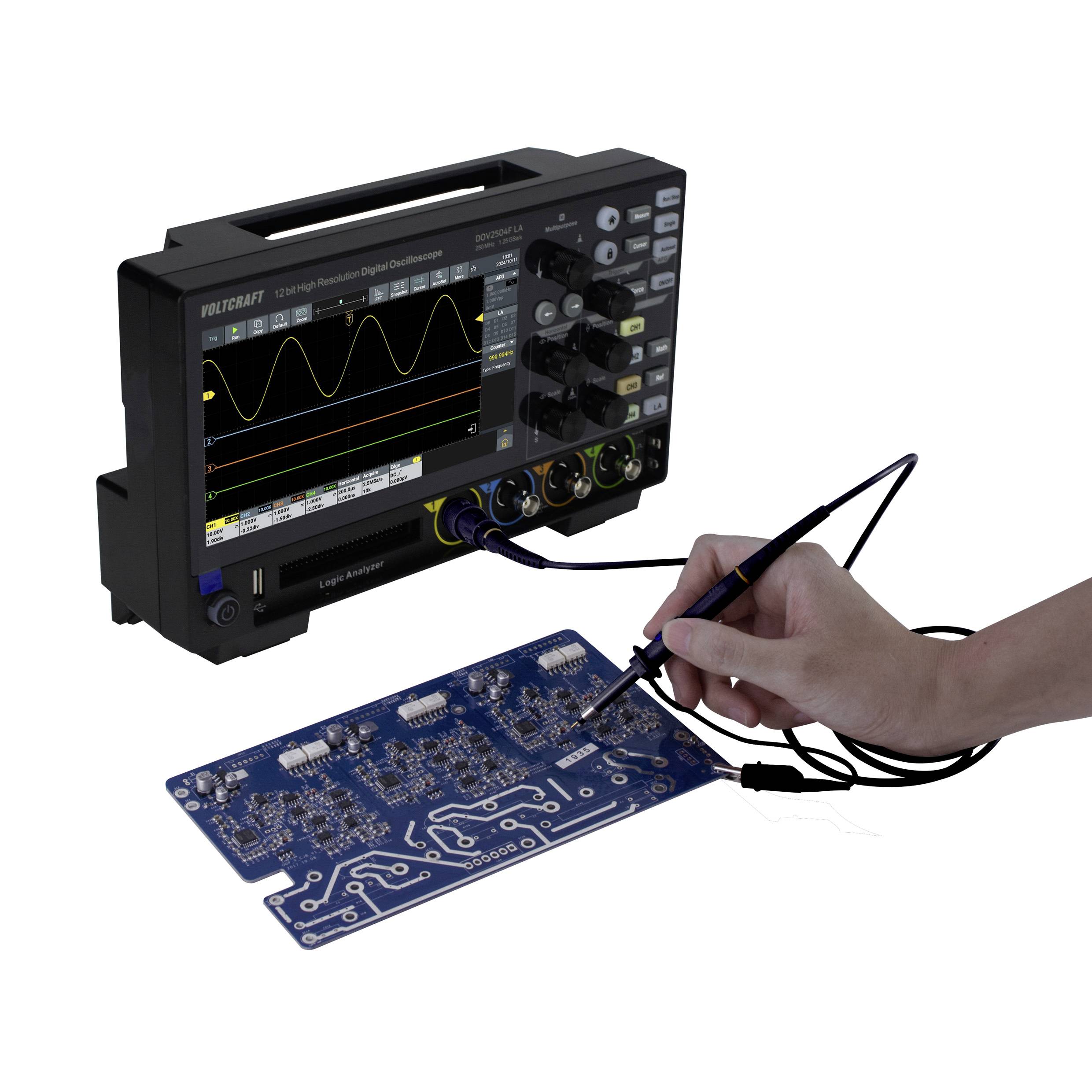 A hand is holding the probe of an oscilloscope connected to a blue circuit board. Waveforms are visible on the oscilloscope screen.