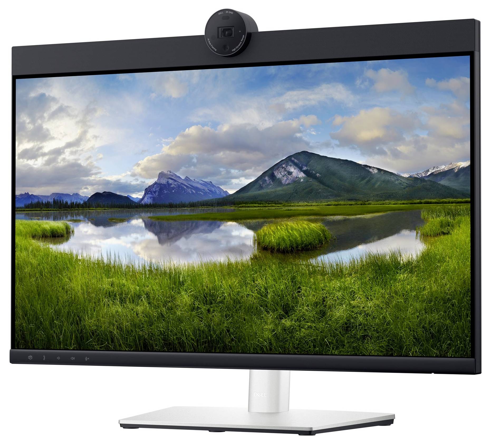 A computer monitor displays a landscape image with mountains, a lake and a green meadow beneath a cloudy sky.
