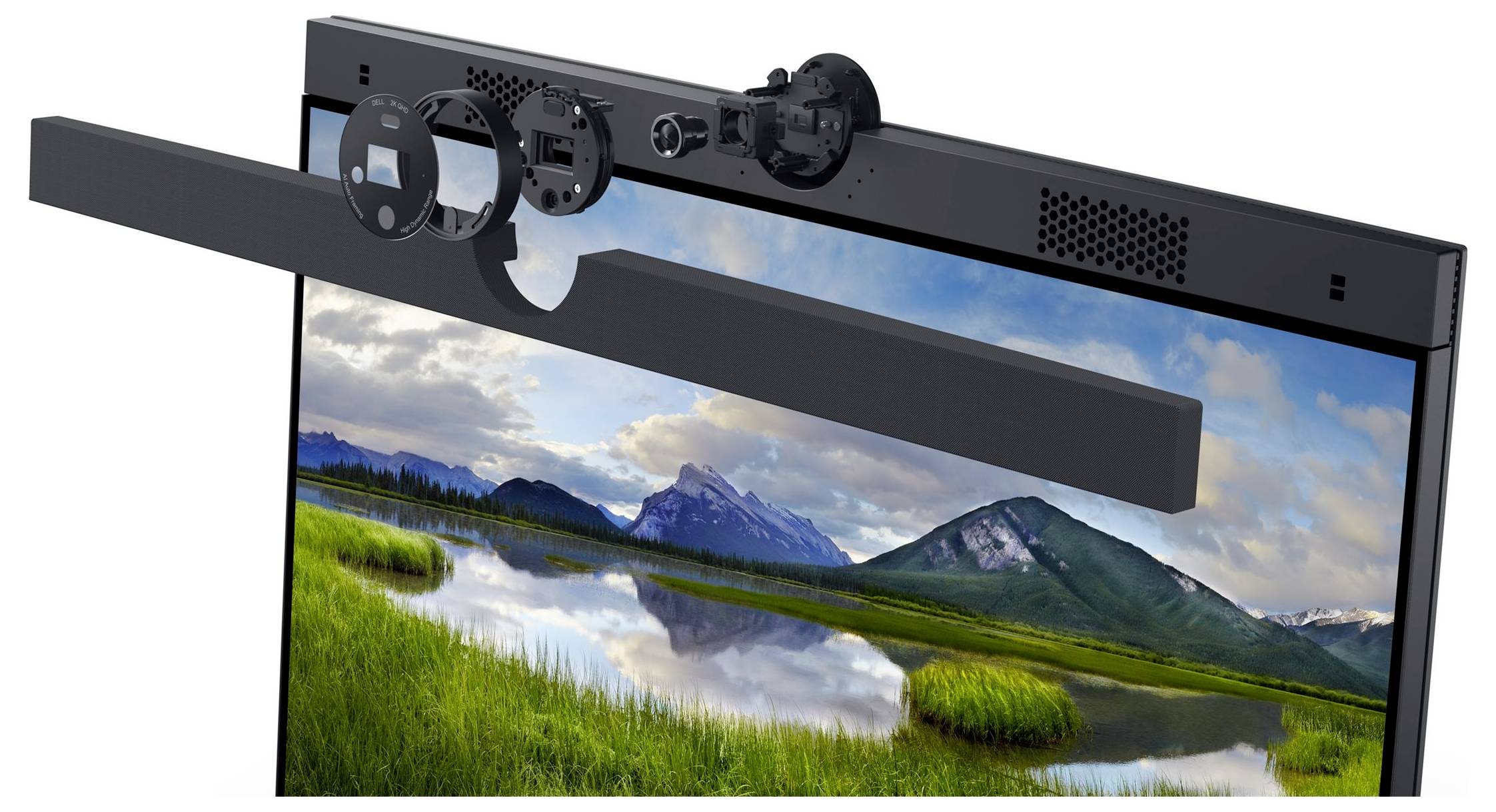 Computer screen displaying a mountain landscape in the background. Parts of the housing, including speakers and camera, are shown in cross-section.