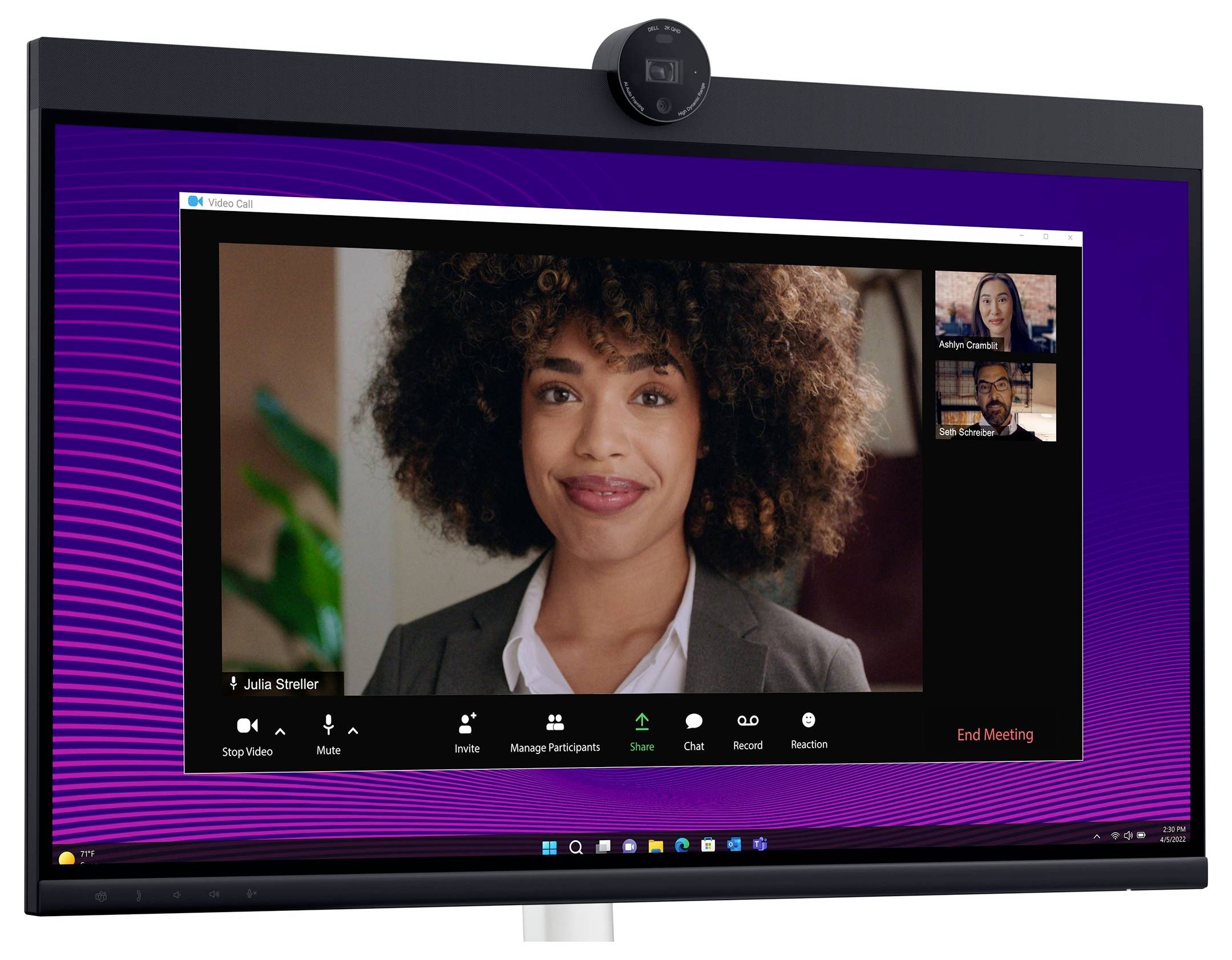 Video conference on a screen with three people, main person smiling in the foreground. Meeting control options visible.