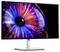 A Dell monitor displays a colourful image with an abstract, iris-like pattern consisting of vibrant lines and points.