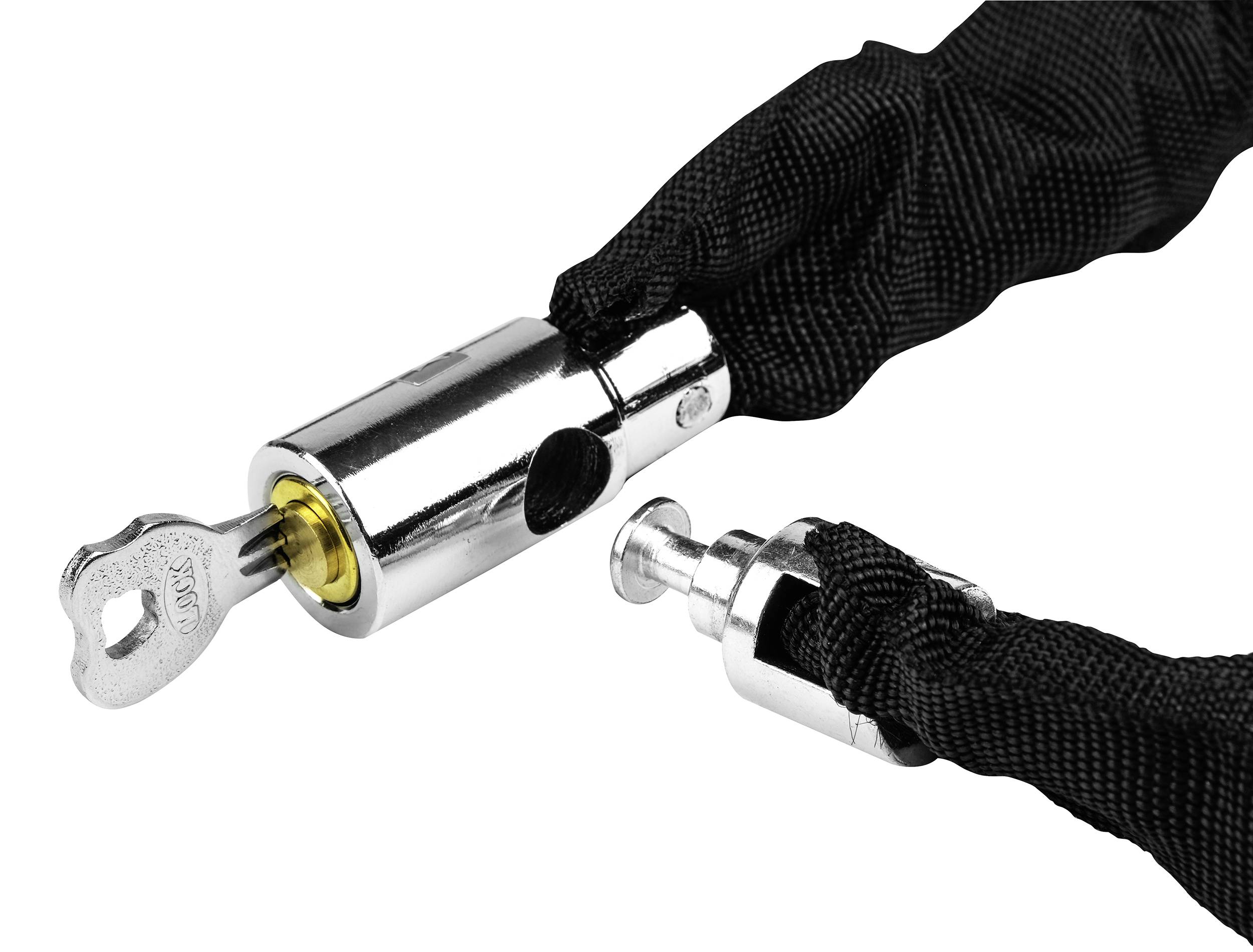 A metal bicycle lock with a black fabric cover is unlocked with a key. The key is inserted in the lock.